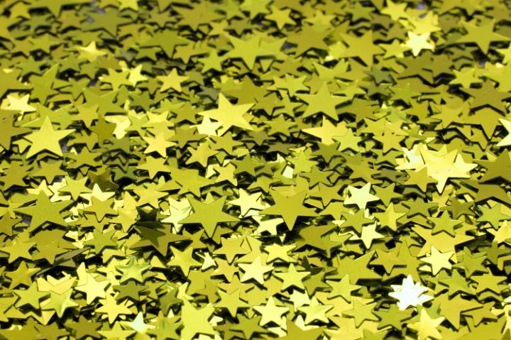 a bright colorful background of sparkling reflective yellow star shapes