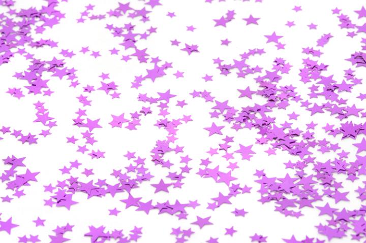 a clean white background scattered with colourful pink star confetti