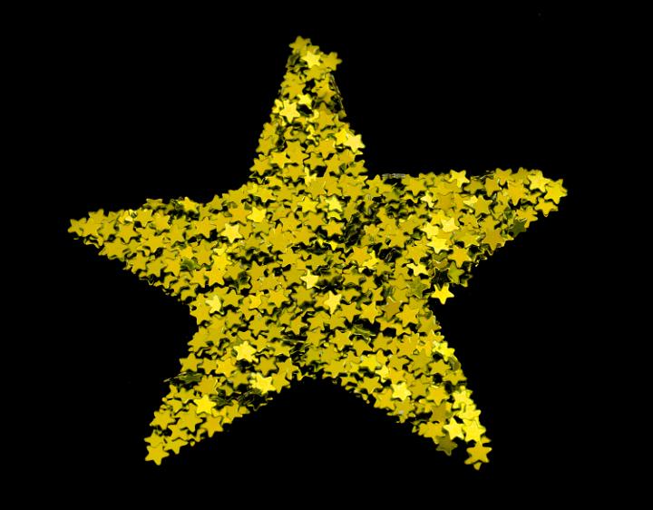 Multiple small shiny gold stars arranged to form a single large golden Christmas star on a black background