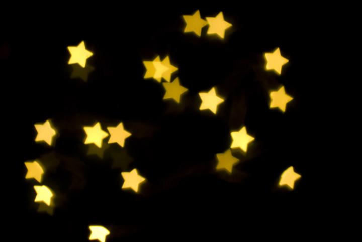 background of glowing yellow star shapes