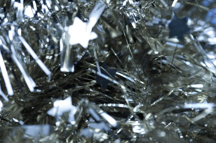 Abstract Christmas background of glittering silver tinsel with stars