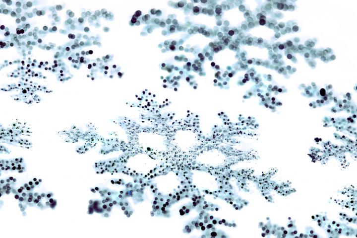 a background photos of christmas snowflake shapes with bokeh highlights