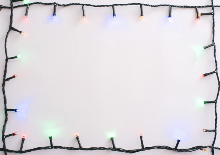 Bright garland lying around the edges. Copy space. White background