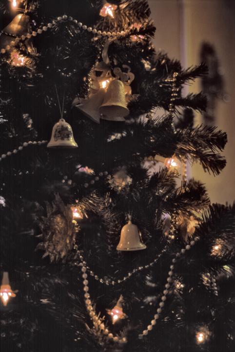 a traditionally decorated christmas tree with beads and ceramic hanging bells
