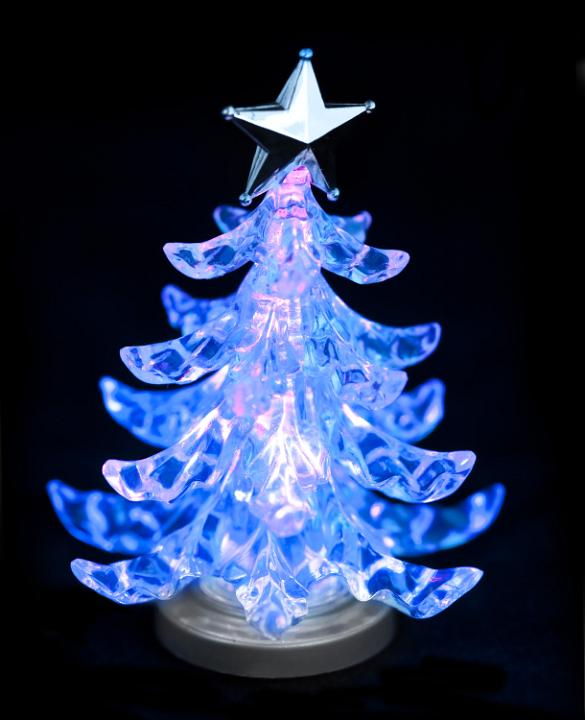 a glowing christmas tree shaped ornament