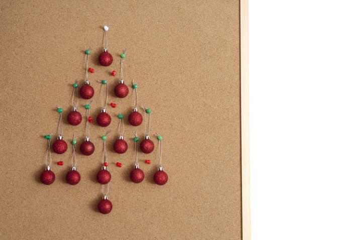 Office Christmas tree balls hanging on cork noticeboard board