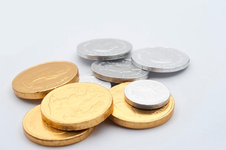 Gold and silver chocolate coins wrapped in metallic foil for a special candy treat on a festive occasion