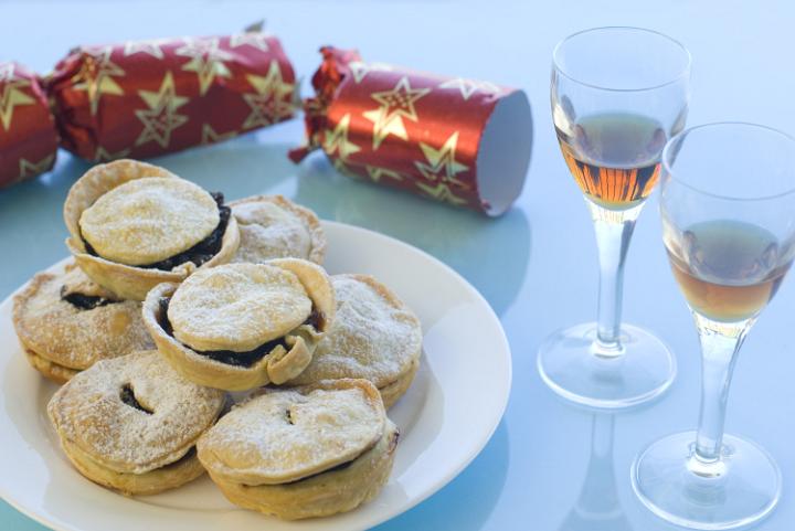 a plate of christmas mincemeat pies and a pulled christmas cracker