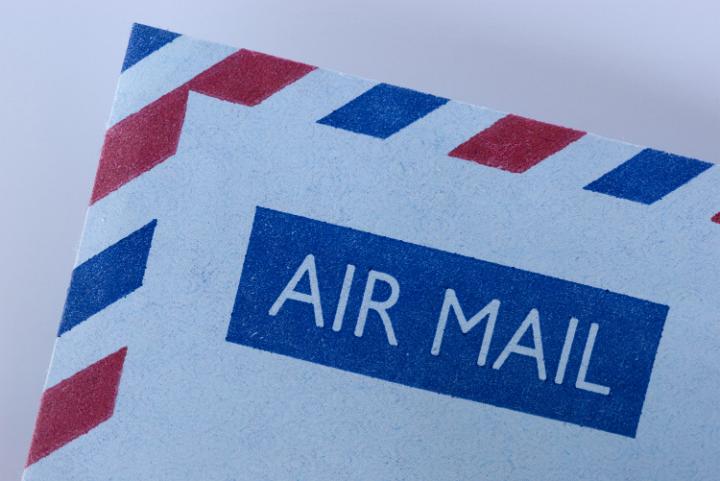 an airmail envelope with the distinctive blue and red striped border