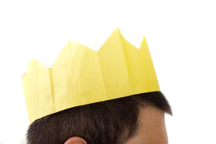 profile view of a mans head with a yellow paper party hat
