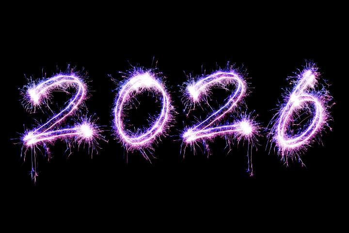 Celebration of new year in pink and purple coloured sparking trail numbers