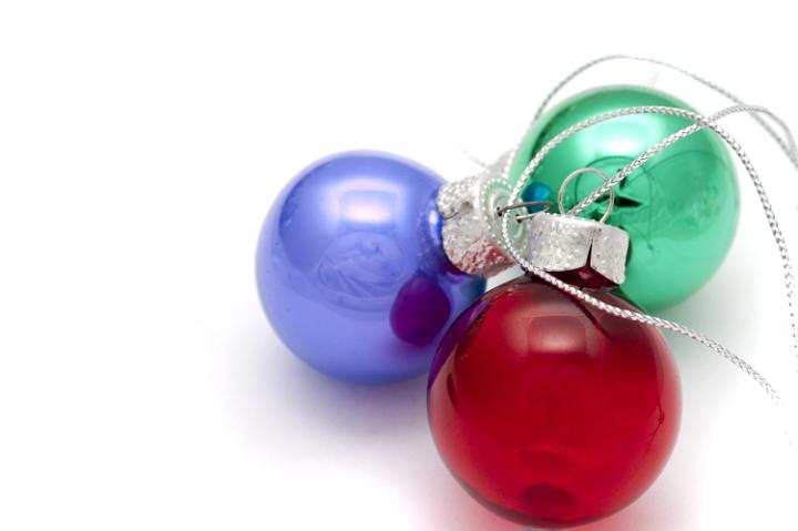 three small christmas ornaments on a white background