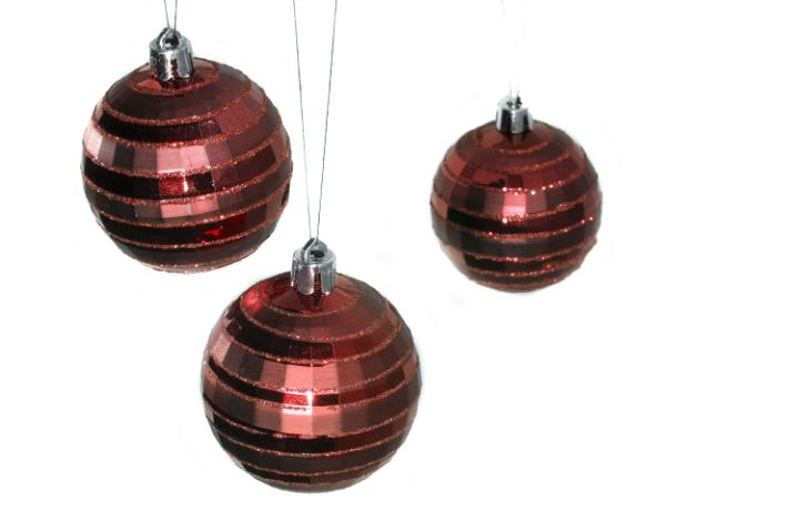 a trio of red hanging christmas baubles
