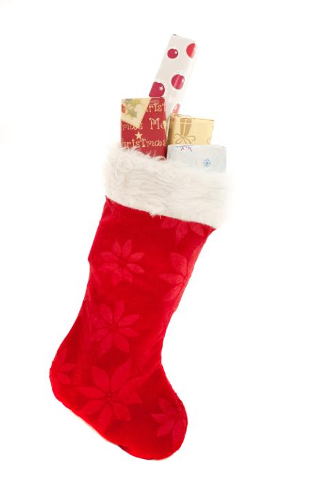 Isolated red Christmas stocking filled with holiday with gifts with copy space for your seasonal greeting