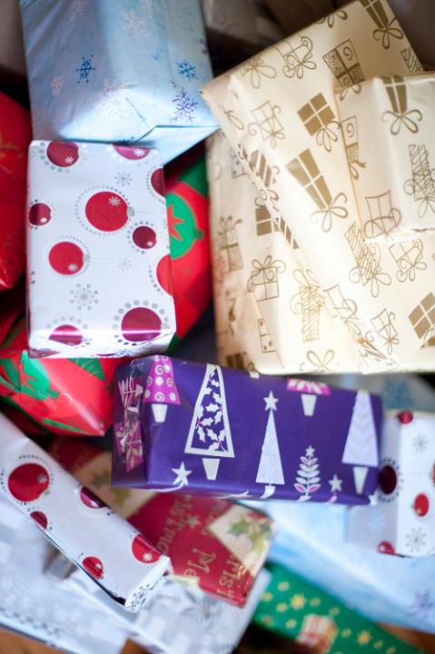 Close-up of Christmas gift boxes wrapped with decorative paper with seasonal patterns