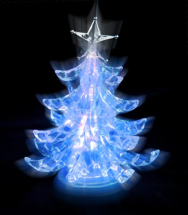 rays of light shining from a christmas tree shaped lamp