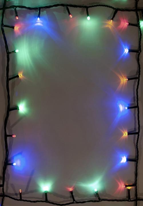 Lighted brigtful garland around the edges. Copy space