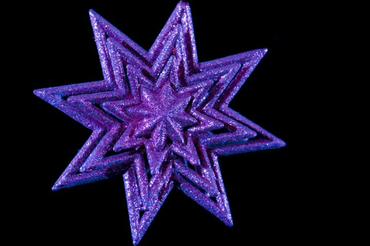 a purple colored glitter covered christmas star