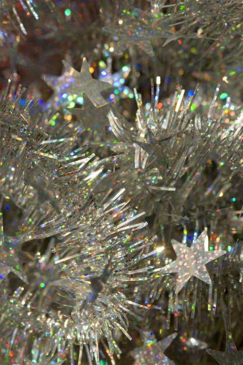 a festive silver and multicolour sparkling background of tinsel