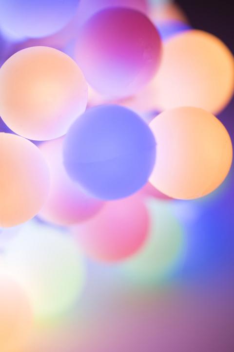 Christmas background of circular pastel colored lights in a soft blur of shallow dof focus and copy space for your seasonal greeting