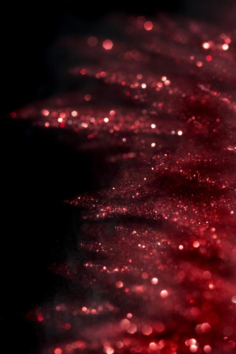a glittering red background with defuse bokeh highlights