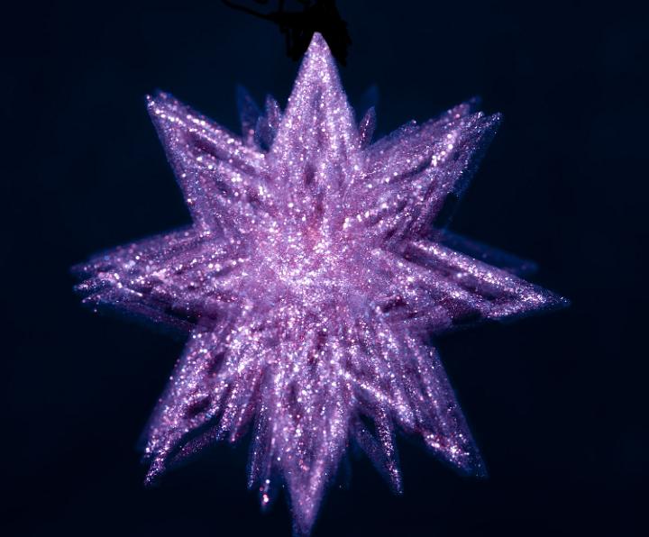 a glittery christmas star decoration with spinning motion effect