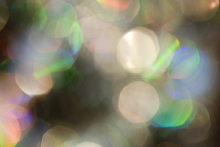a defocused festive silver sparkling background of bokeh circles