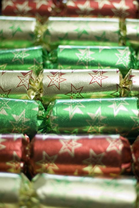 a row of christmas crackers imaged with a narrow depth of field (out of focus in the backbackground and foreground)