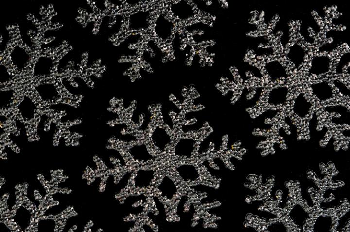 christmas snowflake shape decorations on a black backdrop