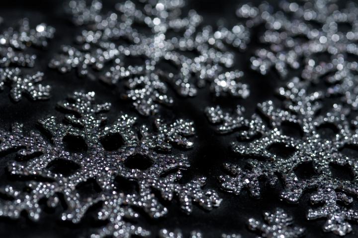 a background picture of christmas snowflake decorations on a black background