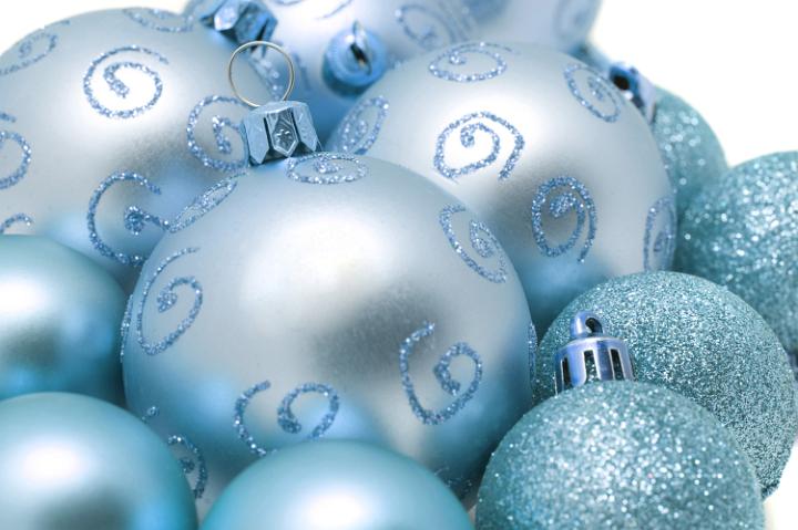 Christmas bauble background of cyan blue balls of different sizes, some with glitter patterns and textures