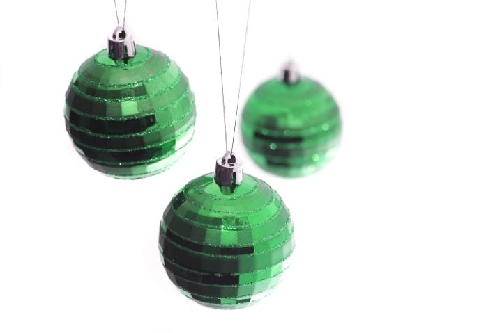 a trio of hanging green christmas tree baubles