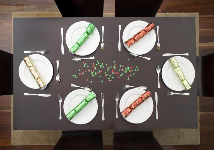 a festive dinner table set up for 6 people to enjoy a celebration meal