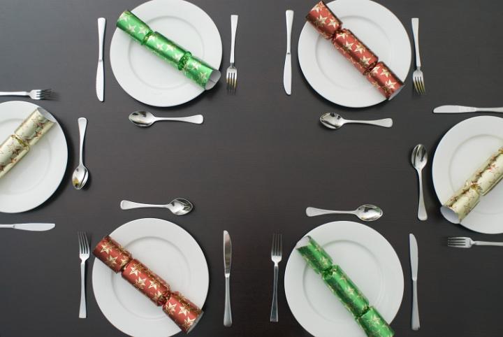 a festive dinner table set up for 6 people to enjoy a celebration meal