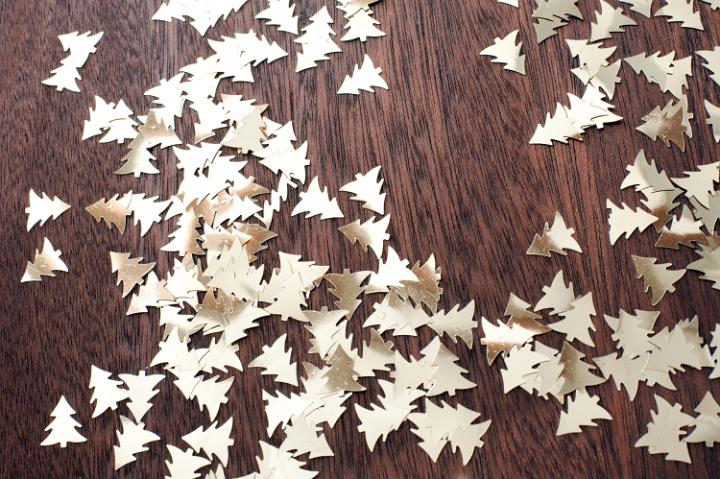 Many little cut out trees decoration on wooden table