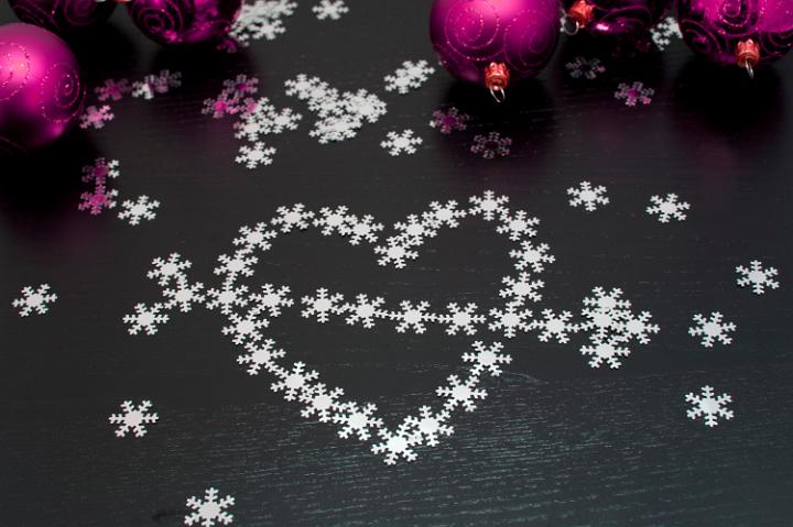 Christmas heart and arrow formed of multiple small snowflakes for your message of love and hope at Christmas