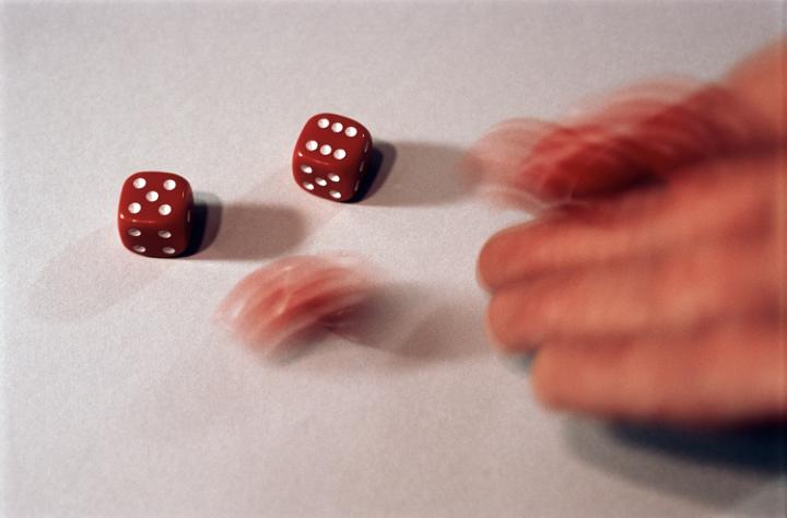 christmas board games, a blurred hand throwing several red dice