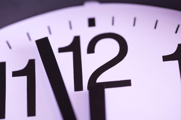 Clock hands approaching midnight on New Years Eve counting down towards the festive celebration to welcome the new year