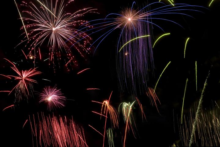a background comprising on various firework explosions and colours