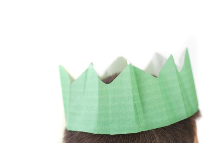 a green coloured paper christmas party hat