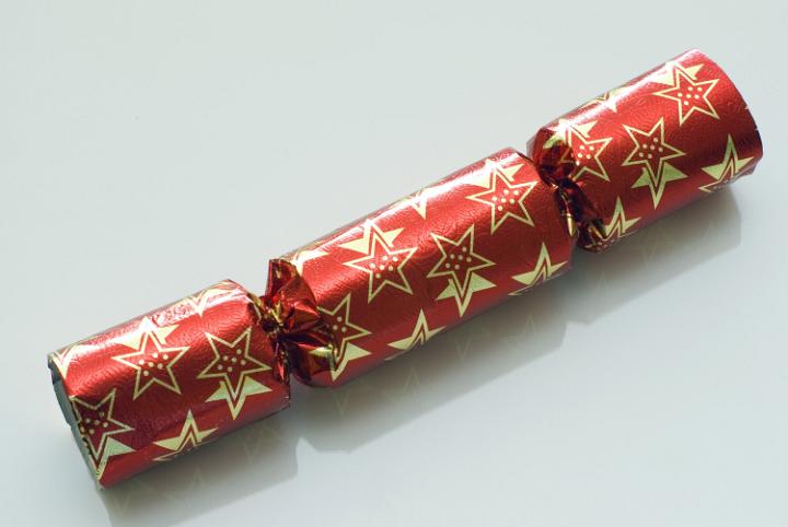 A red christmas bonbon (cracker) on a plain background