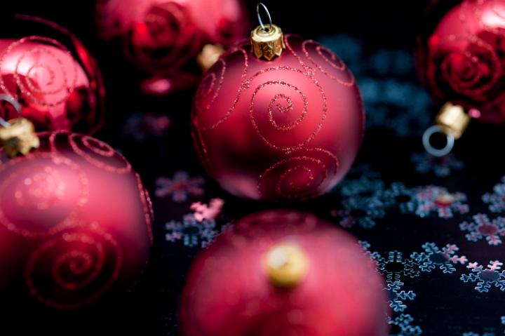 Background of richly coloured maroon Christmas balls for your seasonal greetings with selective focus