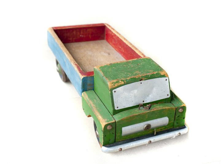 Old battered rustic wooden toy truck, a much loved kids toy, isolated on white as a gift for Christmas