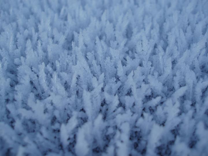 a background of ice crystals create after a sharp night frost