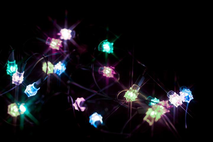 Strand of multicoloured festive glowing Christmas or party lights for celebrating a special event on a dark background