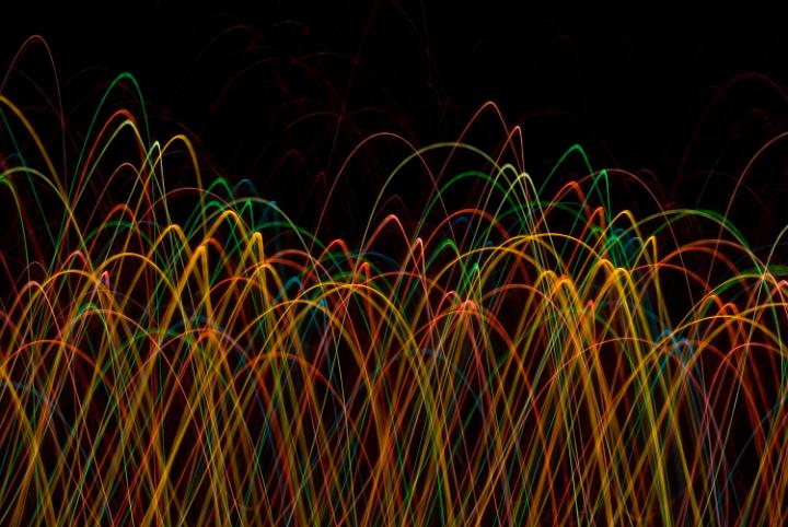 abstract background of red orange and green light trails
